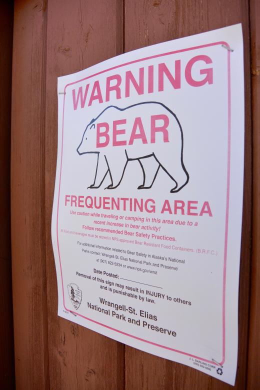 Pictured Right: A sign on the outhouse door warns of a bear frequenting the area. Photo by Sam Weis